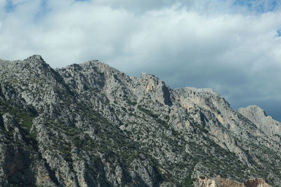 Low angle view of rocky mountains against sky