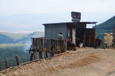 Rear view of people on landscape against sky