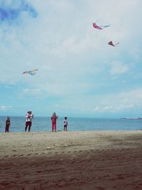 People flying kites at beach