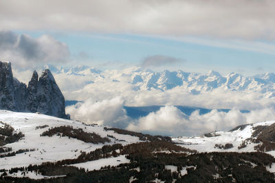 Mountain winter ski resort scenery. snowy picks and coniferous forest. italy, dolomites. copy space