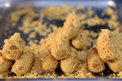 Battered and deep-fried unripe rice and grated coconut banana rollsy, thai dessert.