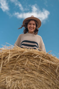 Portrait of happy man wearing hat against sky