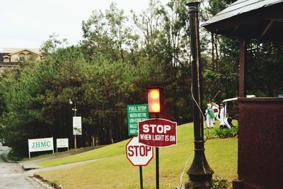 Road sign by trees