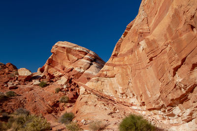 Scenic view of mountain against blue sky