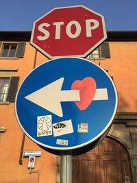 Low angle view of road signs against building