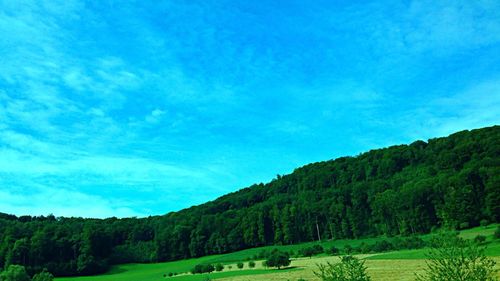 Scenic view of mountains against blue sky