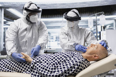Rear view of architects working at construction site