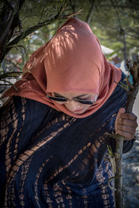 Close-up of woman holding plants