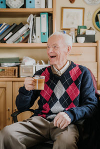 Midsection of man with coffee while sitting at home