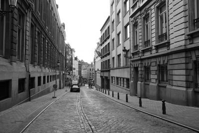 Street amidst buildings against clear sky