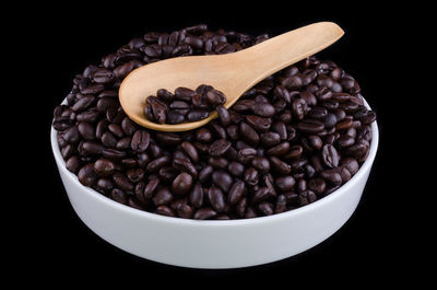 Close-up of coffee beans against black background