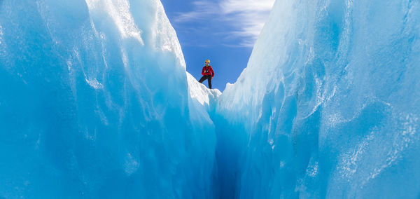 Man on snowcapped mountain against sky