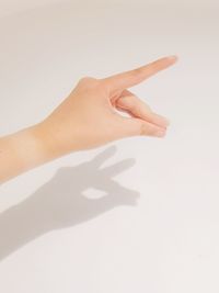 Close-up of hand against white background