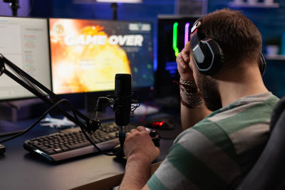 Person losing video games on live stream with chat. man using headphones and microphone to broadcas