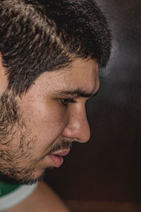 Close-up portrait of young man looking away