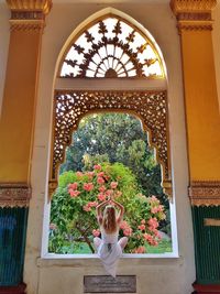 Woman seen through archway