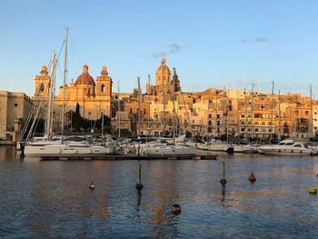 Sailboats in city at waterfront