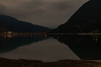 Scenic view of lake against sky at night