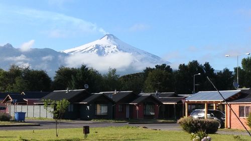 Houses on mountain against sky