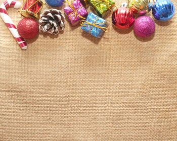 High angle view of christmas decorations on jute