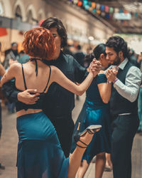 Young couple standing on mobile phone