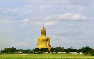 Large golden buddha image of wat muang temple view from the back, ang thong province of thailand