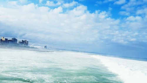 Scenic view of sea against cloudy sky