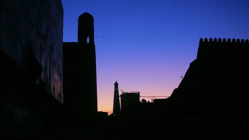 Low angle view of silhouette buildings against sky at night