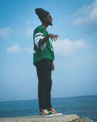 Full length of man standing near sea against sky