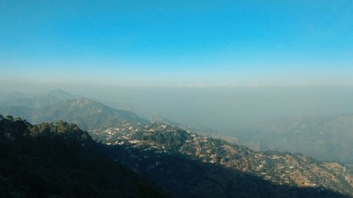 Scenic view of mountains against clear blue sky