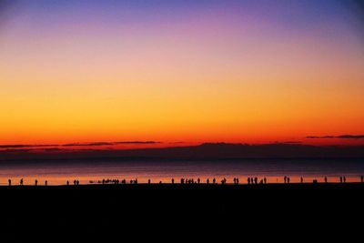 Scenic view of sea against romantic sky at sunset