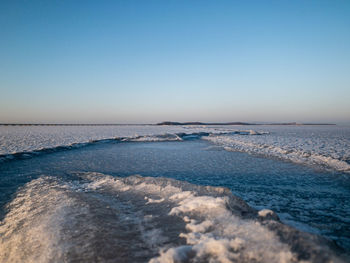 Scenic view of sea against clear blue sky