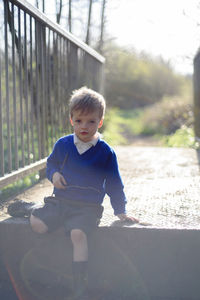 Portrait of boy sitting on steps