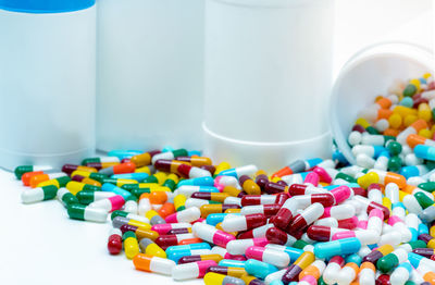 Close-up of multi colored bottles on table