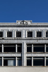 Low angle view of buildings against clear blue sky