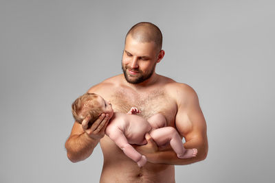 Young man looking away against white background