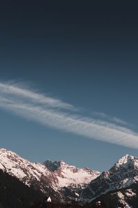 Low angle view of snowcapped mountains against sky