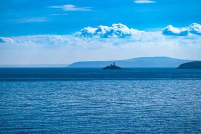Scenic view of sea against blue sky