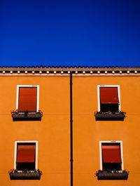 Low angle view of building against clear blue sky