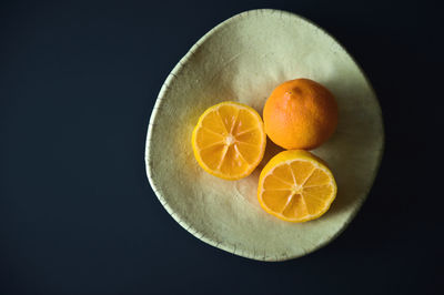 Close-up of oranges against black background