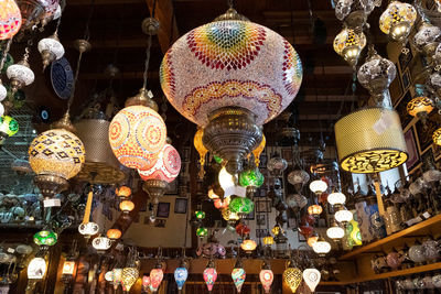 Low angle view of illuminated lanterns hanging at market stall