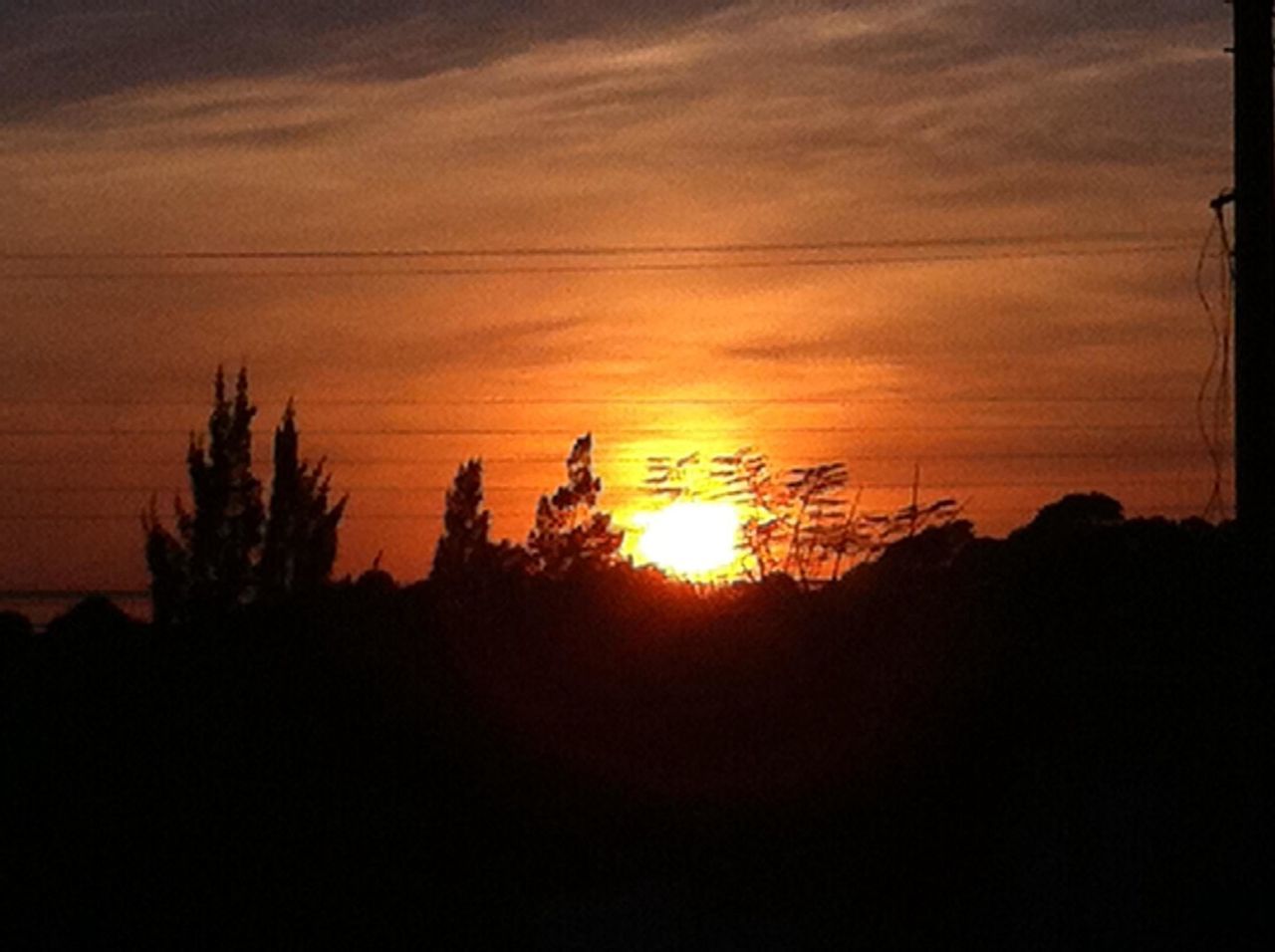 sunset, silhouette, sun, orange color, scenics, sky, tranquil scene, beauty in nature, tranquility, nature, idyllic, sunlight, cloud - sky, dark, landscape, dramatic sky, outline, tree, cloud, outdoors