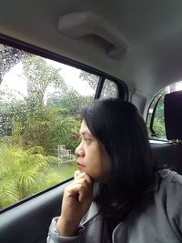 Portrait of woman sitting in car