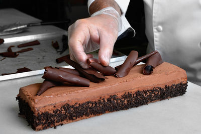 Midsection of man preparing cake