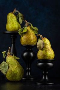 Close-up of fruits on table against black background