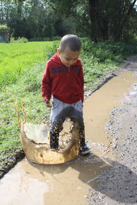 Full length of boy playing in park