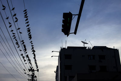 Low angle view of crane against sky