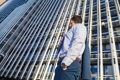 Low angle view of businessman against skyscraper