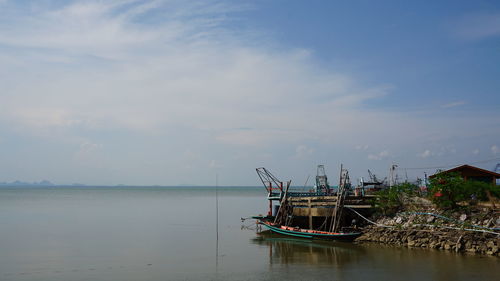 Fishing boat in sea against sky