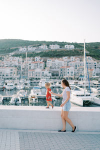 Full length of young woman standing in city